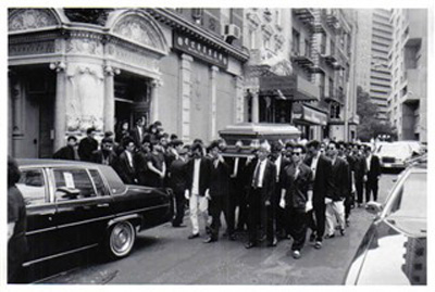 Gang members parade the coffin of a fallen
gang brother through Chinatown.