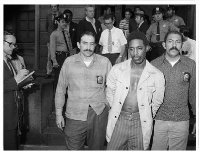 Dhoruba Bin Wahad is taken into custody outside a Bronx<br/> police precinct station house.